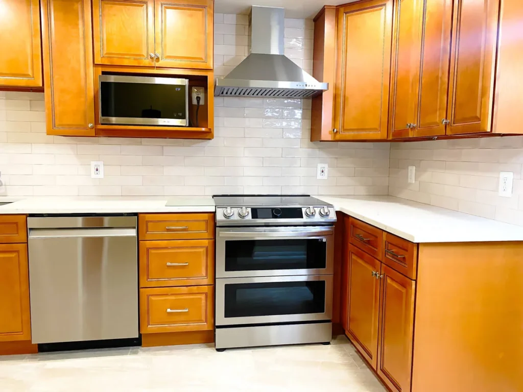 Kitchen remodel with quartz countertops, subway tile backsplash, and stainless steel appliances