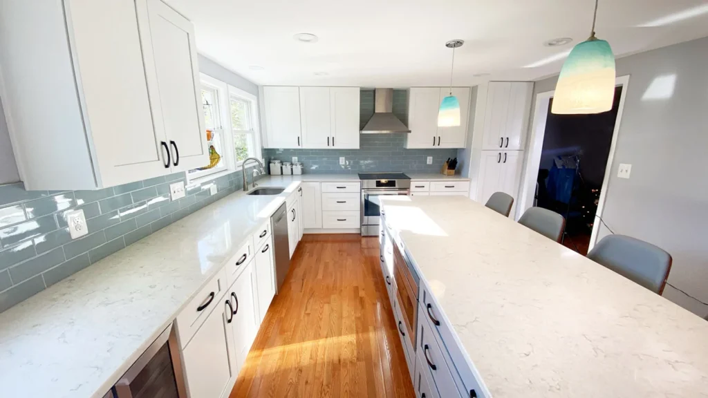 Modern kitchen remodel with long island, galley layout, and quartz countertops