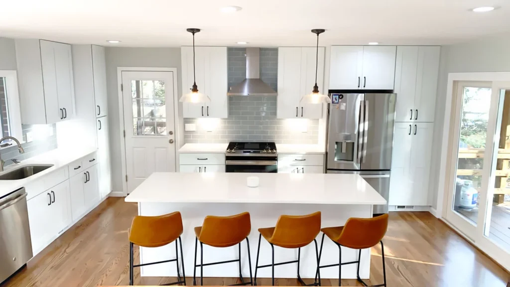 Modern kitchen with centered island seating and white shaker cabinets