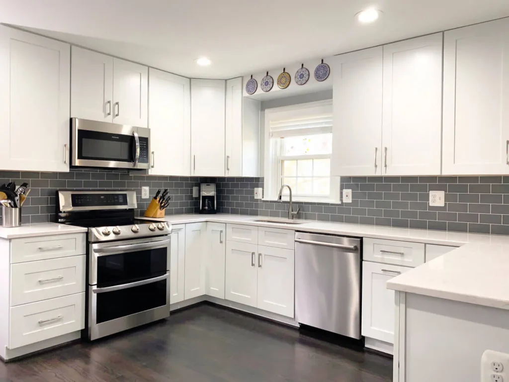 Brass kitchen faucet with undermount sink and white quartz countertop in modern kitchen