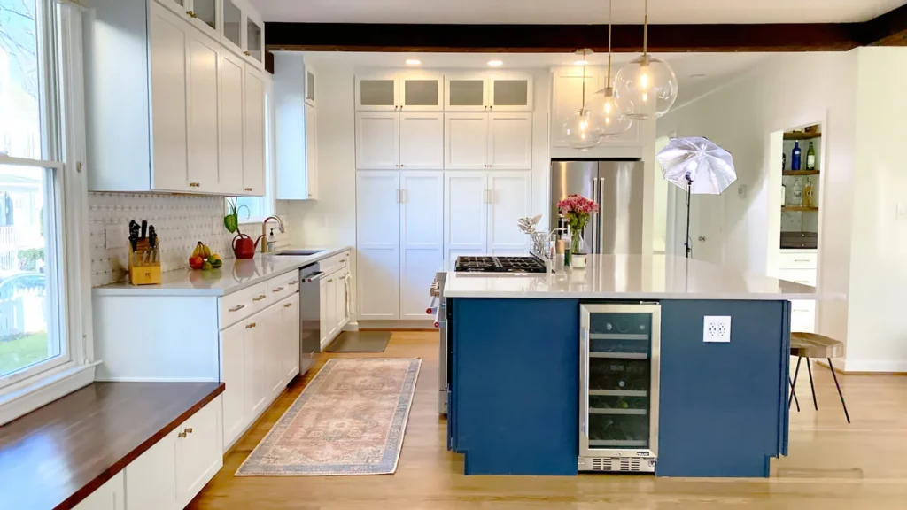 Open concept kitchen with large island, wine cooler, quartz countertops, and custom cabinets
