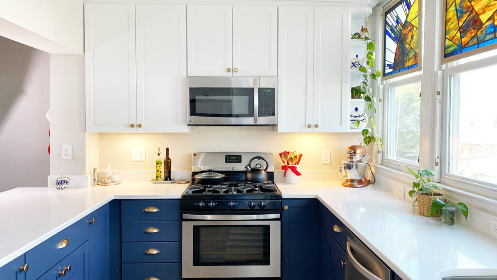 Symmetrical kitchen design with blue cabinets, quartz countertops, and centered cooking area