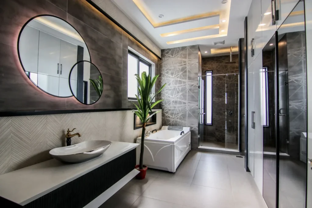 Luxury modern bathroom with freestanding bathtub, walk-in glass shower, and floating vanity with vessel sink