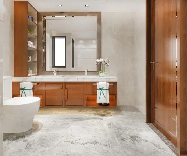 Modern bathroom with wood vanity, marble flooring, and large framed mirror