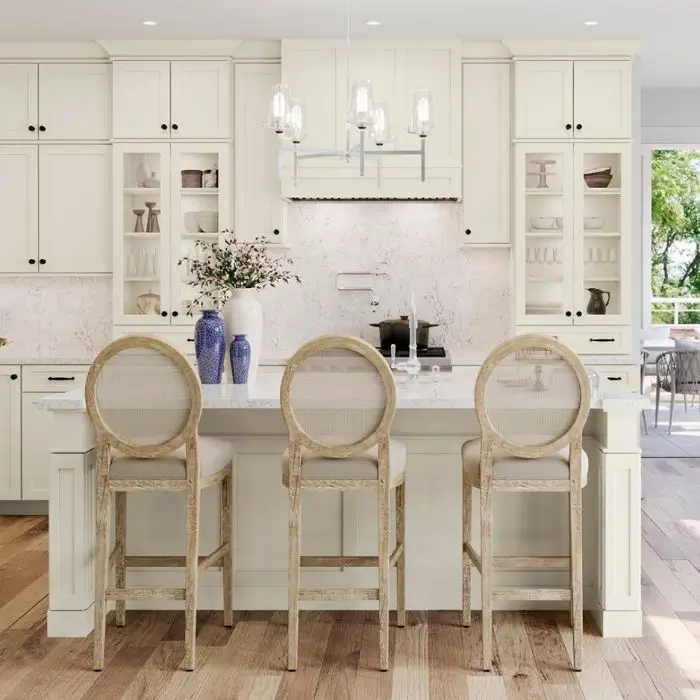White shaker kitchen with island seating and marble backsplash