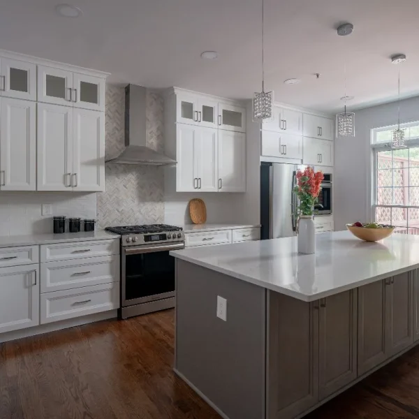 Kitchen with contrasting island, white cabinets, and large windows