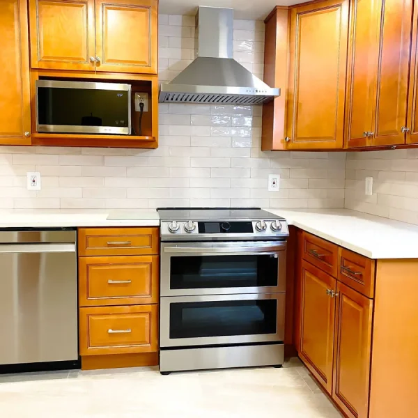 Kitchen remodel with quartz countertops, subway tile backsplash, and stainless steel appliances