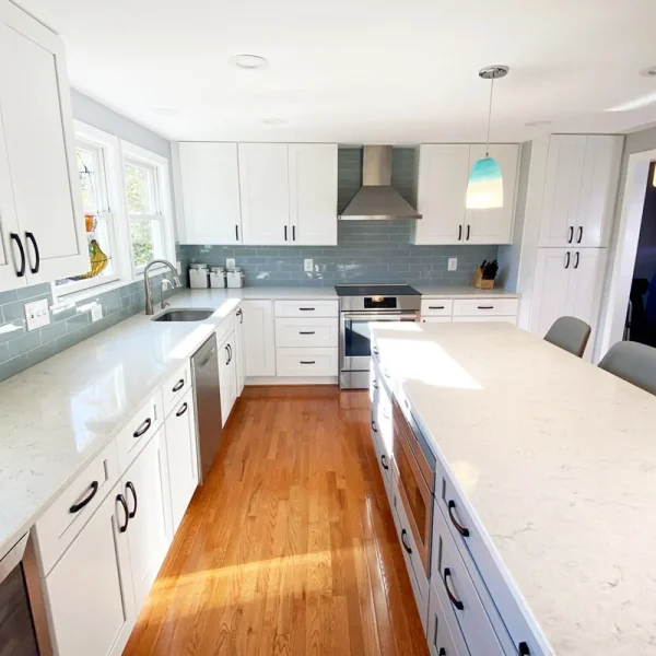 Modern kitchen remodel with long island, galley layout, and quartz countertops