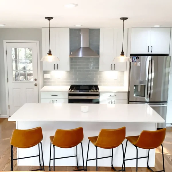 Modern kitchen with centered island seating and white shaker cabinets