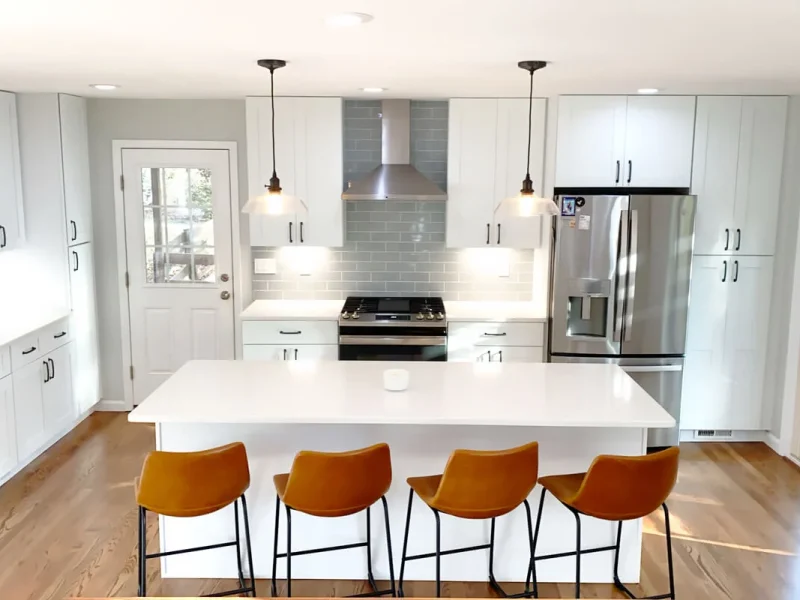 Modern kitchen with centered island seating and white shaker cabinets