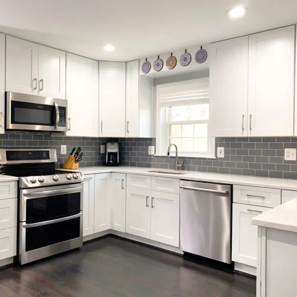 Brass kitchen faucet with undermount sink and white quartz countertop in modern kitchen