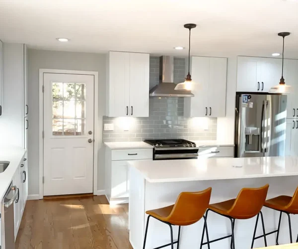 Modern white kitchen with quartz island and bar seating