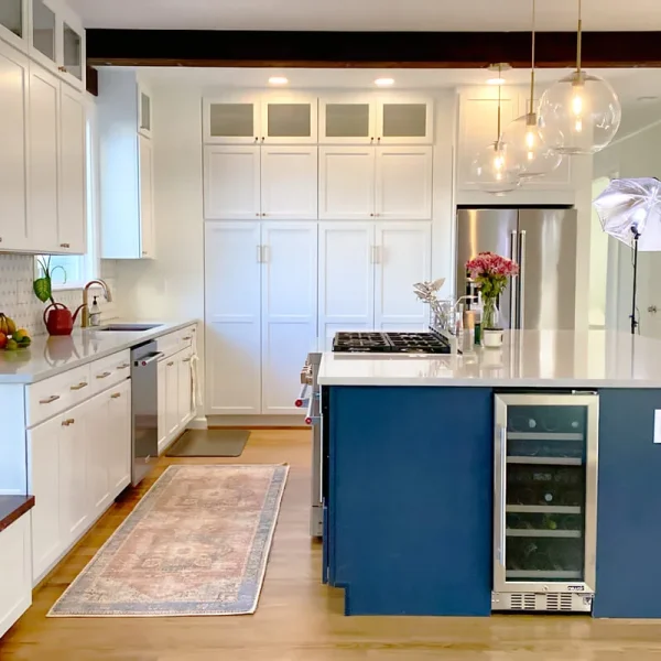Open concept kitchen with large island, wine cooler, quartz countertops, and custom cabinets
